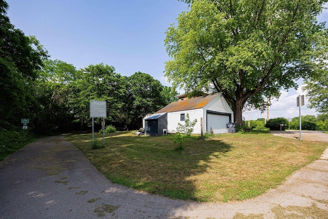 1871 Galloway Rd, Galloway, OH 43119 - view of home's exterior with a detached garage, an outdoor structure, and a lawn