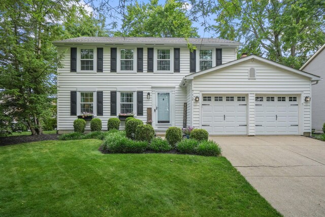 712 Suntree Dr, Westerville, OH 43081 - colonial house with concrete driveway, an attached garage, and a front lawn