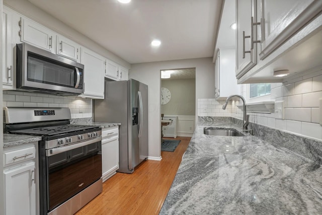 712 Suntree Dr, Westerville, OH 43081 - kitchen with appliances with stainless steel finishes, light wood-style flooring, white cabinetry, light stone countertops, and recessed lighting