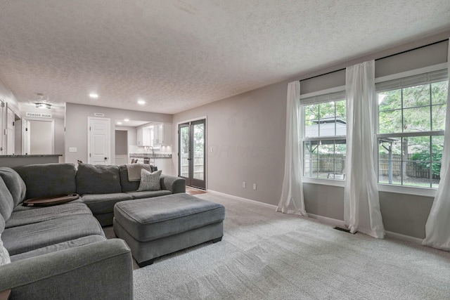 712 Suntree Dr, Westerville, OH 43081 - living area featuring a textured ceiling, plenty of natural light, light carpet, and recessed lighting