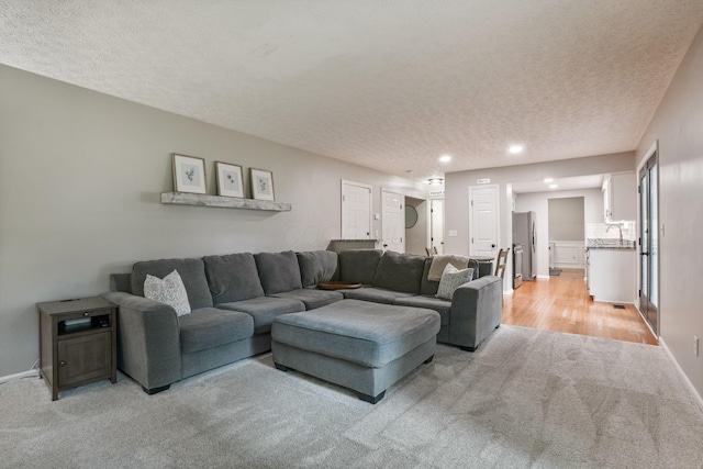 712 Suntree Dr, Westerville, OH 43081 - living room with light colored carpet, a textured ceiling, and recessed lighting