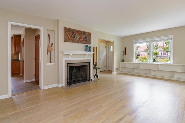 2006 Kentwell Rd, Upper Arlington, OH 43221 - unfurnished living room featuring a tile fireplace and light wood finished floors