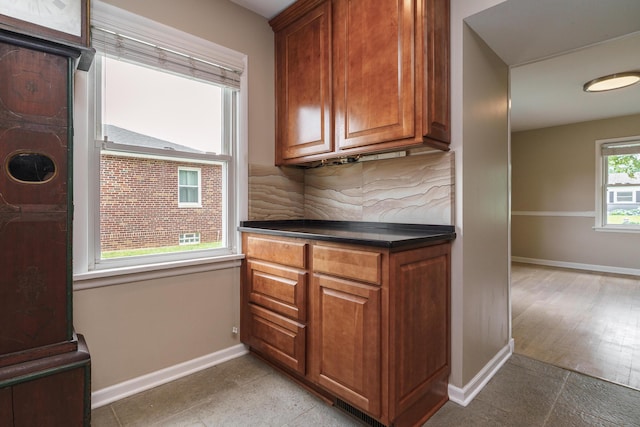 2006 Kentwell Rd, Upper Arlington, OH 43221 - kitchen with backsplash, brown cabinetry, and dark countertops