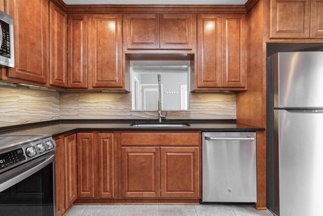 2006 Kentwell Rd, Upper Arlington, OH 43221 - kitchen featuring stainless steel appliances, dark countertops, and brown cabinets