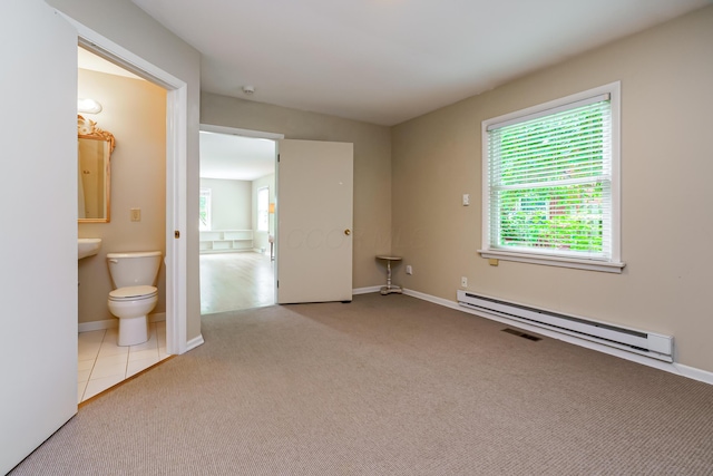 2006 Kentwell Rd, Upper Arlington, OH 43221 - unfurnished bedroom featuring a baseboard radiator, multiple windows, carpet flooring, and ensuite bath
