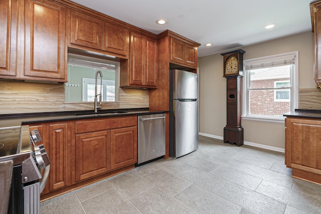 2006 Kentwell Rd, Upper Arlington, OH 43221 - kitchen with stainless steel appliances, dark countertops, recessed lighting, backsplash, and brown cabinetry