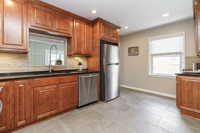 2006 Kentwell Rd, Upper Arlington, OH 43221 - kitchen featuring appliances with stainless steel finishes, dark countertops, backsplash, recessed lighting, and brown cabinetry