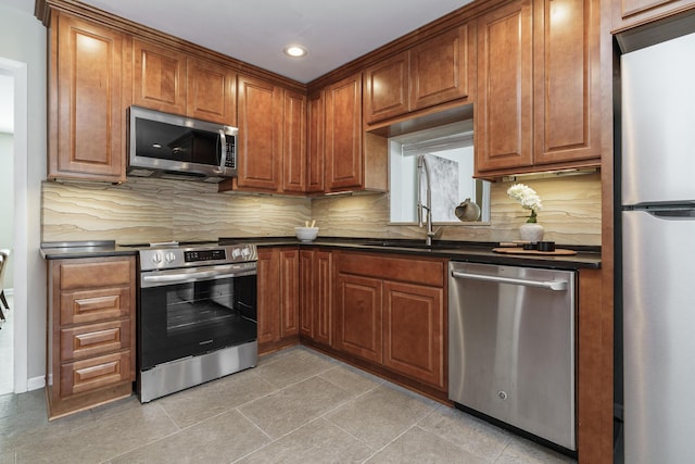 2006 Kentwell Rd, Upper Arlington, OH 43221 - kitchen with stainless steel appliances, dark countertops, recessed lighting, brown cabinets, and backsplash