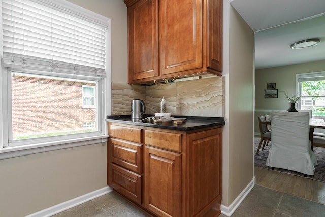 2006 Kentwell Rd, Upper Arlington, OH 43221 - kitchen with brown cabinetry, backsplash, and dark countertops