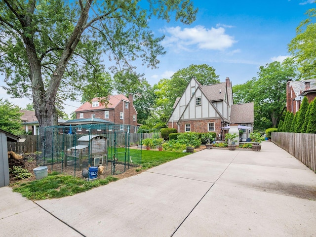 2629 E Broad St, Columbus, OH 43209 - view of front of home featuring brick siding, exterior structure, and an outdoor structure
