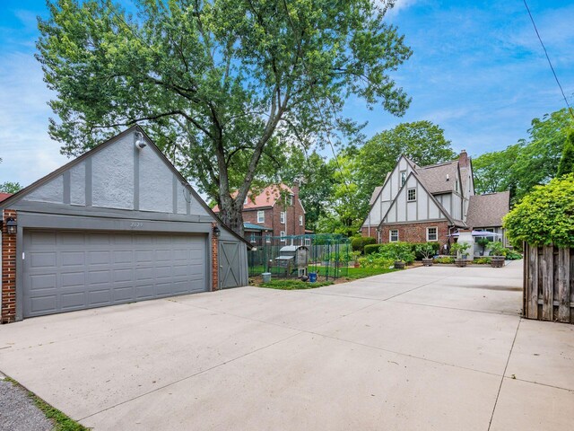 2629 E Broad St, Columbus, OH 43209 - view of home's exterior featuring brick siding, an outbuilding, and a garage