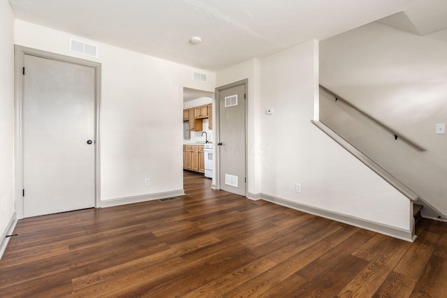 437-441 S Glenwood Ave, Columbus, OH 43223 - unfurnished living room featuring dark wood-style floors and stairs