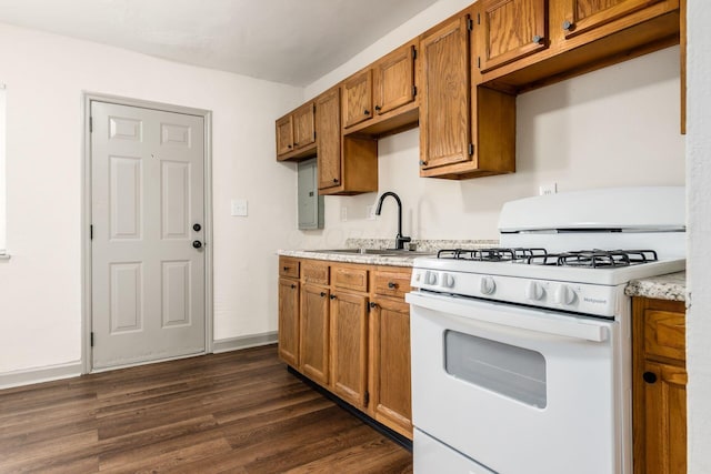 437-441 S Glenwood Ave, Columbus, OH 43223 - kitchen with white range with gas stovetop, light countertops, brown cabinets, and dark wood-type flooring