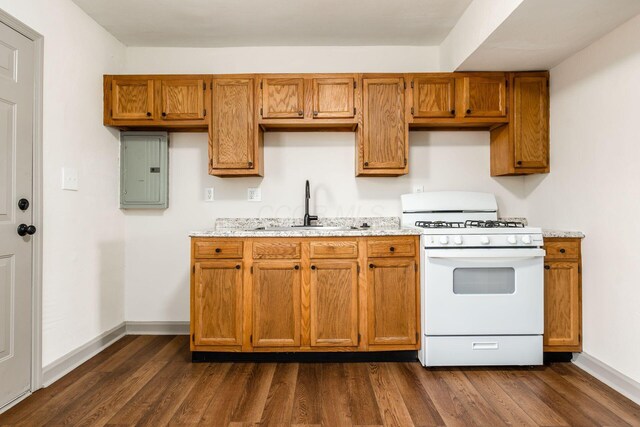 437-441 S Glenwood Ave, Columbus, OH 43223 - kitchen featuring white gas range oven, electric panel, dark wood-type flooring, brown cabinets, and light stone counters