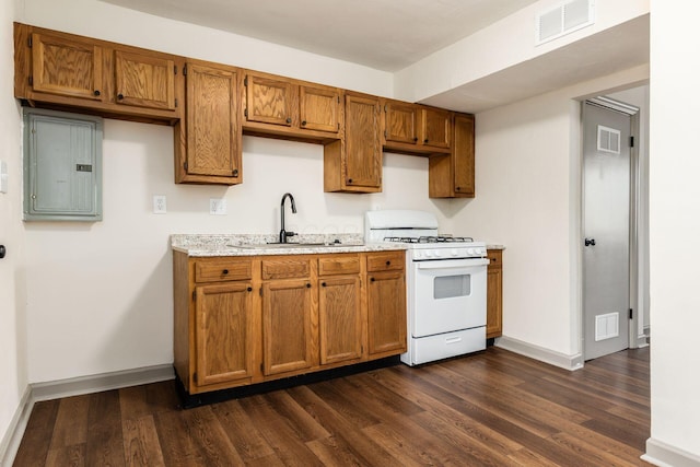 437-441 S Glenwood Ave, Columbus, OH 43223 - kitchen with white gas stove, electric panel, dark wood-style flooring, and brown cabinetry