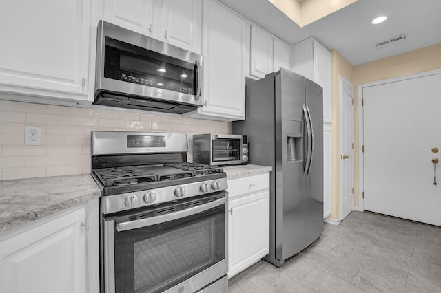 595 Piney Glen Dr, Columbus, OH 43230 - kitchen with stainless steel appliances, white cabinets, decorative backsplash, and recessed lighting
