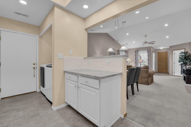 595 Piney Glen Dr, Columbus, OH 43230 - kitchen with tasteful backsplash, open floor plan, washer / dryer, white cabinetry, and a peninsula