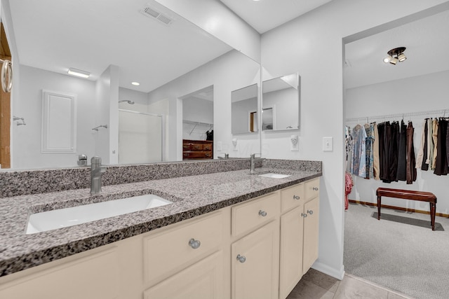 595 Piney Glen Dr, Columbus, OH 43230 - full bathroom featuring a spacious closet, double vanity, a stall shower, and tile patterned floors