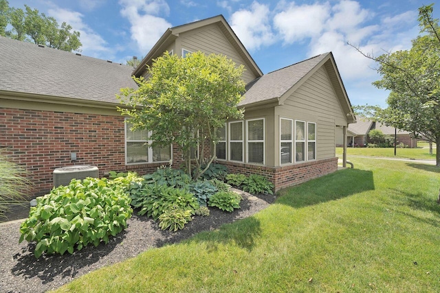 595 Piney Glen Dr, Columbus, OH 43230 - rear view of house with brick siding, a yard, and a shingled roof