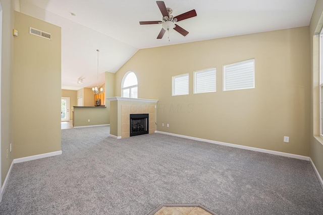 5654 Caledonia Dr, Westerville, OH 43081 - unfurnished living room featuring carpet flooring, vaulted ceiling, a ceiling fan, a fireplace, and a chandelier