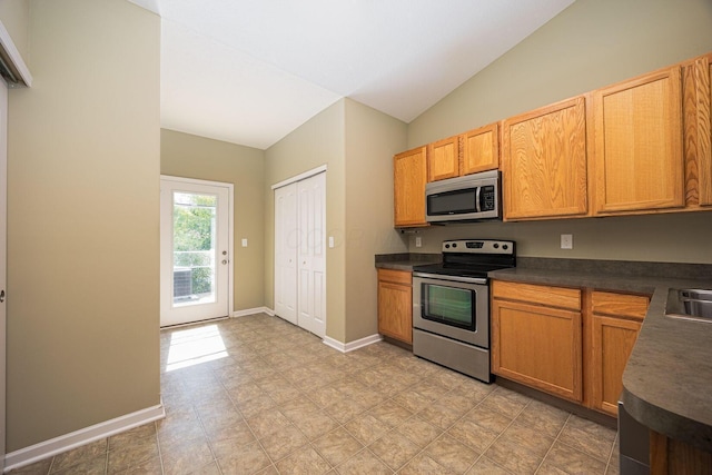 5654 Caledonia Dr, Westerville, OH 43081 - kitchen featuring appliances with stainless steel finishes, dark countertops, lofted ceiling, and light floors