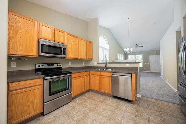 5654 Caledonia Dr, Westerville, OH 43081 - kitchen with stainless steel appliances, a chandelier, a peninsula, dark countertops, and lofted ceiling