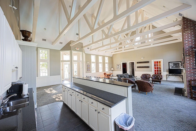 5654 Caledonia Dr, Westerville, OH 43081 - kitchen featuring high vaulted ceiling, open floor plan, dark colored carpet, a center island, and white cabinetry