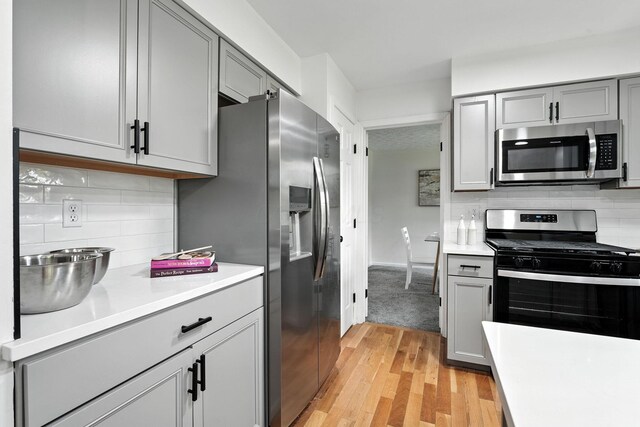 1360 Langston Dr, Columbus, OH 43220 - kitchen with stainless steel appliances, gray cabinets, light wood finished floors, and light countertops