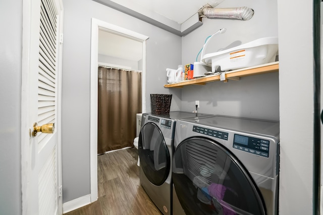 1657 Wilton Dr, Columbus, OH 43227 - washroom with washer and clothes dryer and dark wood finished floors