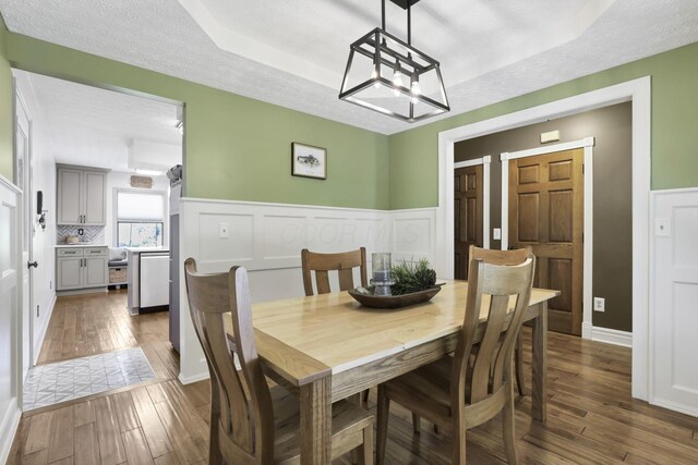 215 Barb Ct, Heath, OH 43056 - dining space featuring wood-type flooring, wainscoting, and a chandelier