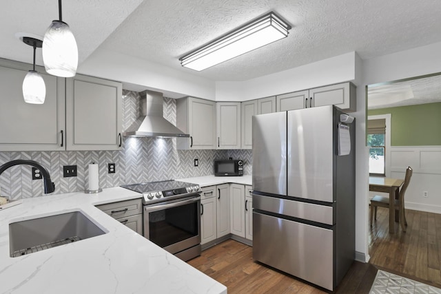 215 Barb Ct, Heath, OH 43056 - kitchen featuring stainless steel appliances, wall chimney exhaust hood, gray cabinets, dark wood-style floors, and a textured ceiling