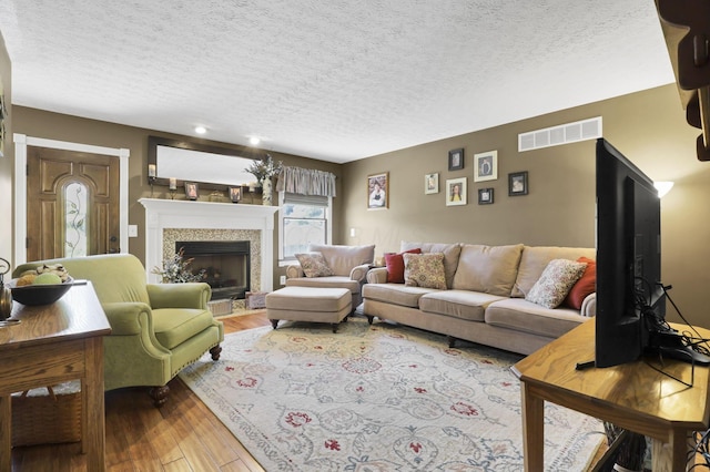 215 Barb Ct, Heath, OH 43056 - living room with a textured ceiling, wood-type flooring, and a fireplace