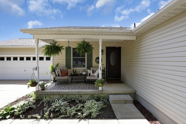 215 Barb Ct, Heath, OH 43056 - view of exterior entry featuring a garage, covered porch, an outdoor hangout area, and concrete driveway