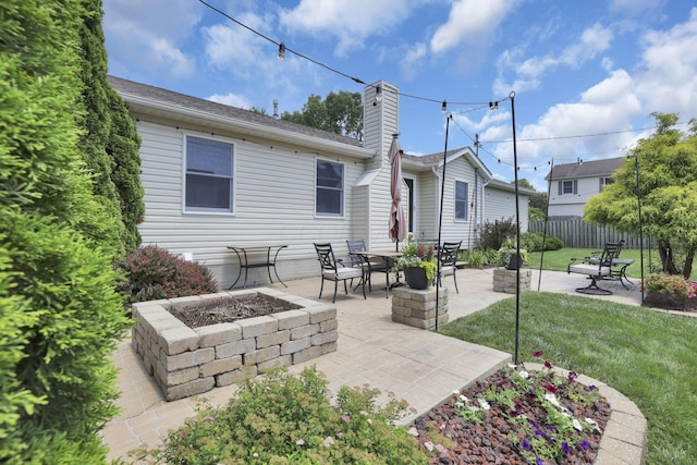 215 Barb Ct, Heath, OH 43056 - rear view of house featuring a fire pit, a patio, and a chimney