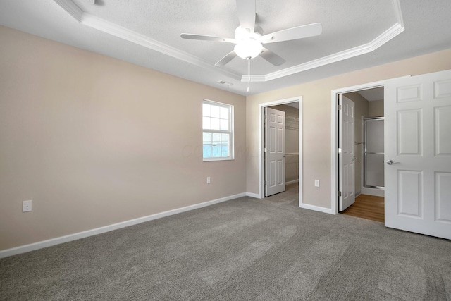 752 Whitetail Lp, Newark, OH 43055 - unfurnished bedroom with a tray ceiling, crown molding, carpet floors, a walk in closet, and a closet