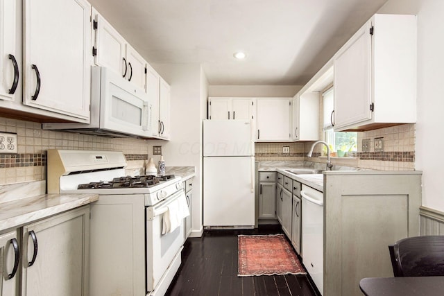 794 E Brighton Rd, Columbus, OH 43224 - kitchen with white appliances, dark wood-style flooring, tasteful backsplash, light countertops, and white cabinets