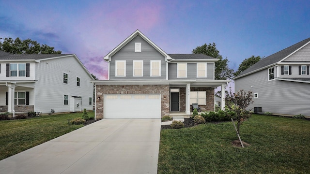 336 Onyx Ln, Delaware, OH 43015 - view of front of property with a garage, concrete driveway, stone siding, a lawn, and covered porch