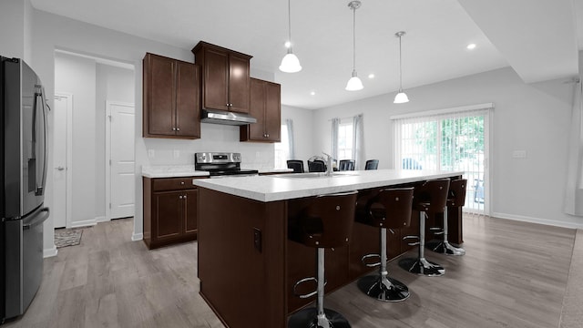 336 Onyx Ln, Delaware, OH 43015 - kitchen with high quality fridge, stainless steel range with electric cooktop, under cabinet range hood, light wood-style flooring, and recessed lighting
