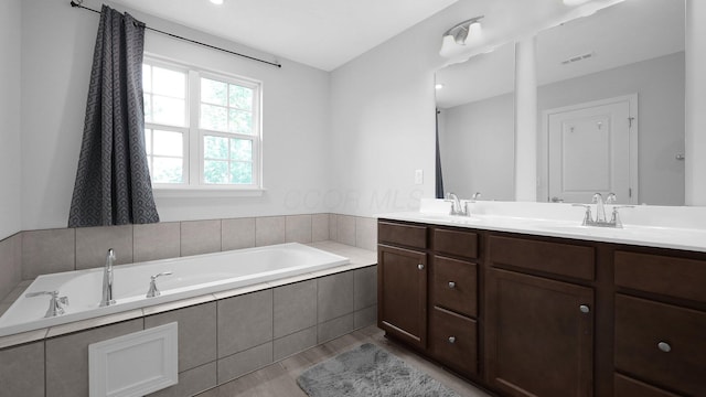 336 Onyx Ln, Delaware, OH 43015 - full bath featuring wood finished floors, double vanity, and a garden tub