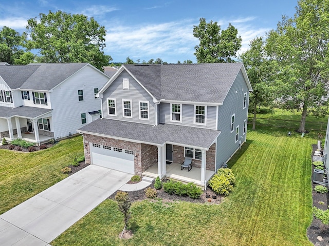 336 Onyx Ln, Delaware, OH 43015 - traditional-style house with covered porch, a shingled roof, an attached garage, driveway, and a front lawn