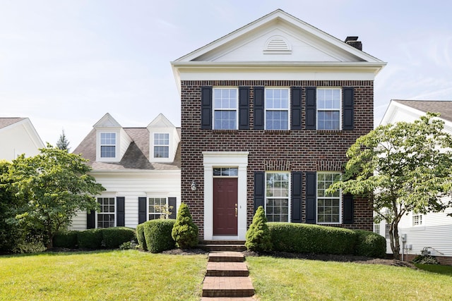 6759 Headwater Trl, New Albany, OH 43054 - view of front of property featuring a front yard, brick siding, and a chimney