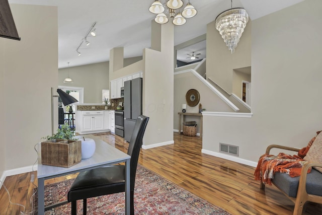 2375 Oakthorpe Dr, Hilliard, OH 43026 - dining space with a chandelier, wood finished floors, stairway, and rail lighting