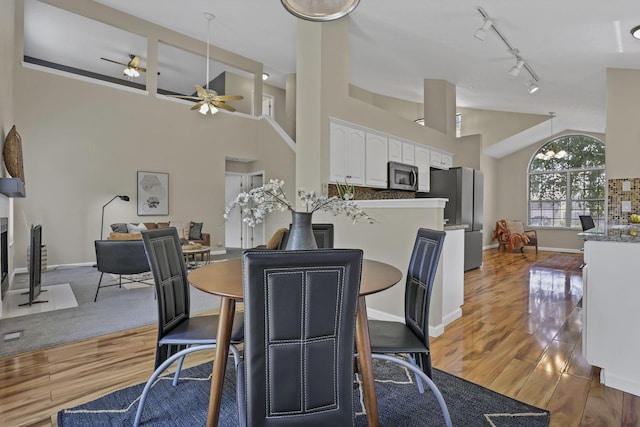 2375 Oakthorpe Dr, Hilliard, OH 43026 - dining room with a ceiling fan, light wood-type flooring, track lighting, and high vaulted ceiling