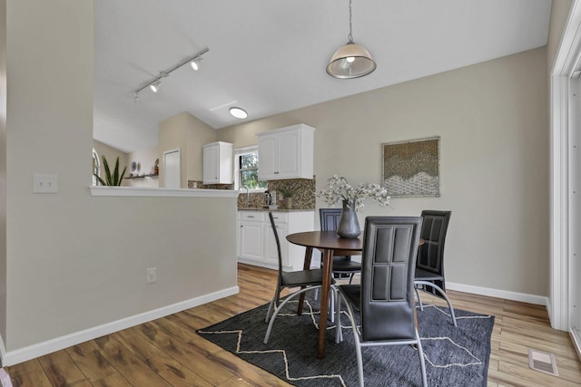 2375 Oakthorpe Dr, Hilliard, OH 43026 - dining room with vaulted ceiling, rail lighting, and light wood-style flooring