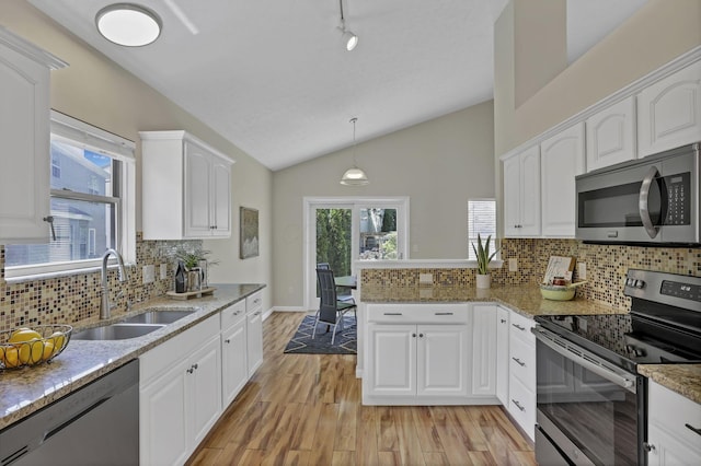 2375 Oakthorpe Dr, Hilliard, OH 43026 - kitchen with appliances with stainless steel finishes, vaulted ceiling, white cabinets, light wood-type flooring, and light stone counters
