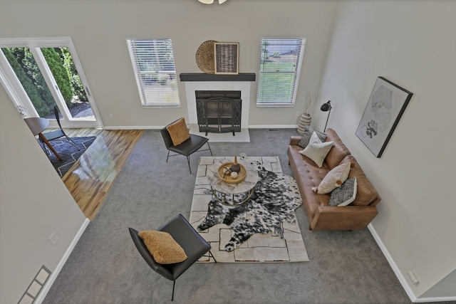 2375 Oakthorpe Dr, Hilliard, OH 43026 - carpeted living area featuring healthy amount of natural light and a fireplace with flush hearth