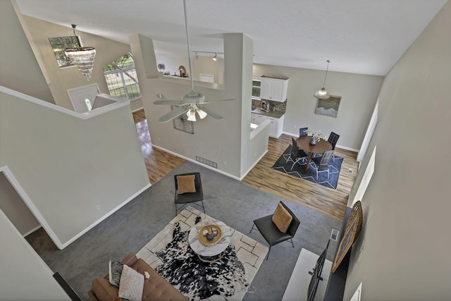 2375 Oakthorpe Dr, Hilliard, OH 43026 - living room with carpet floors, a ceiling fan, lofted ceiling, and wood finished floors