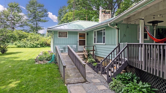 890 Elm Dr, Columbus, OH 43235 - view of front facade featuring a chimney, a front lawn, a metal roof, and stairway