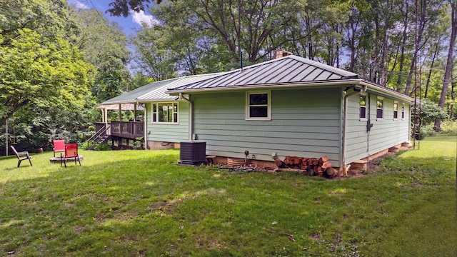 890 Elm Dr, Columbus, OH 43235 - back of house featuring a standing seam roof, a yard, a chimney, and a metal roof