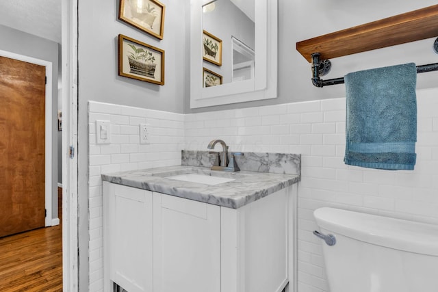 890 Elm Dr, Columbus, OH 43235 - bathroom with tile walls, vanity, and wood finished floors